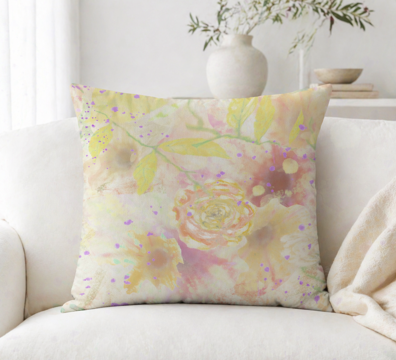 Floral patterned pillow on a white couch with a neutral background