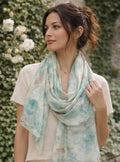 Woman wearing a floral scarf with a blurred natural background