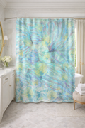 Shower curtain with blue and green abstract pattern in a bathroom setting